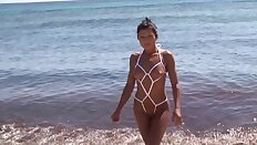 Sexy baby in daring string bikini on the beach