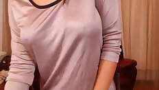 Busty brunette Denise in short dress teases on the webcam.